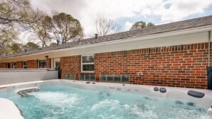 A hot tub with a brick wall backdrop, a window, and a sign indicating no diving. - Cheerful Home W/ Private 15' Swim Spa, Big Fenced Yard, & Fire Pit (Arlington)