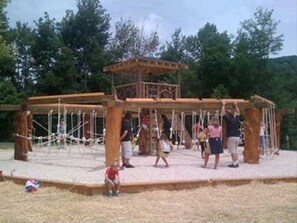 Children can play on the ropes and swings in this park pavilion.