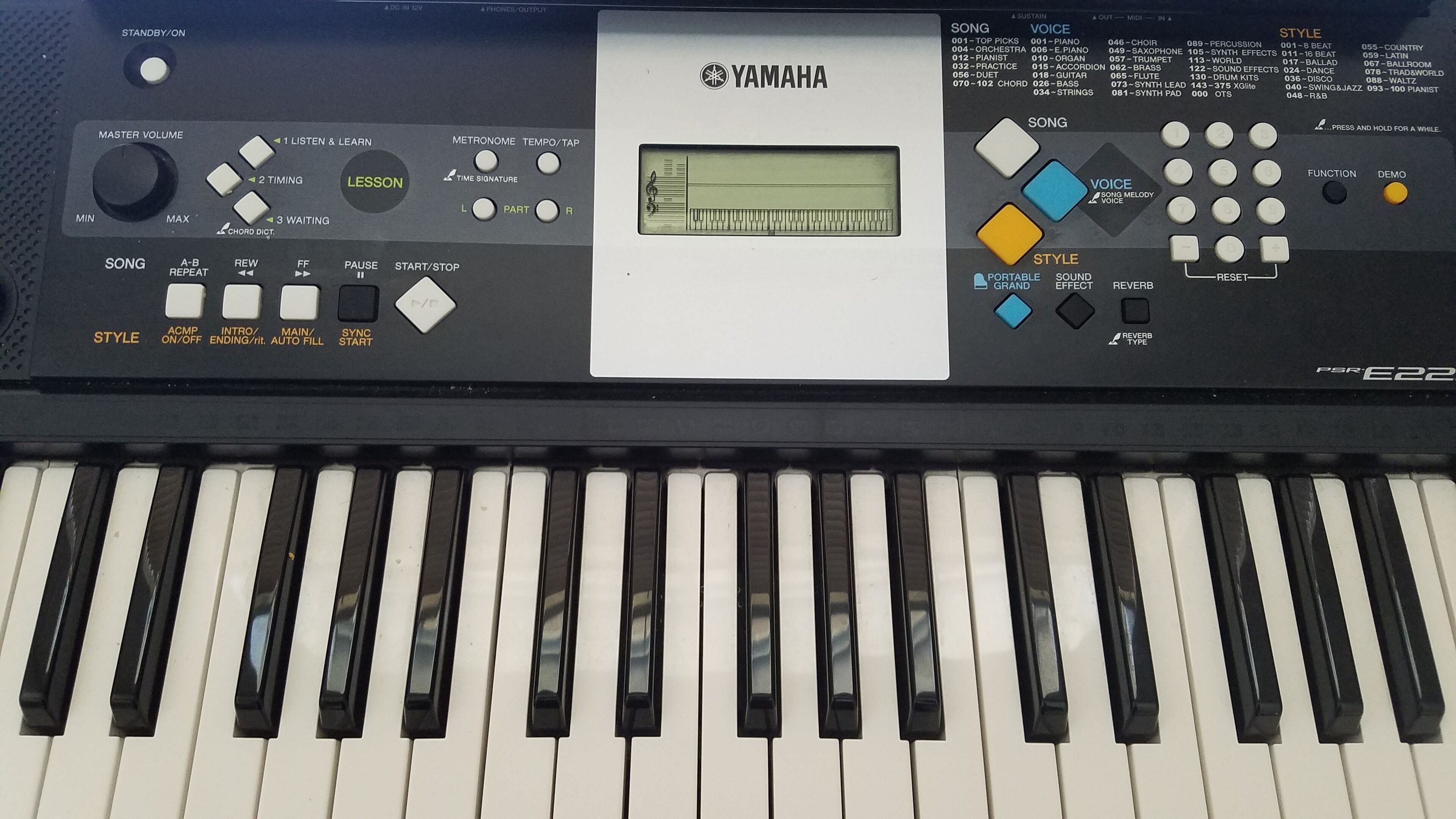 A Yamaha keyboard with various controls and a digital display.