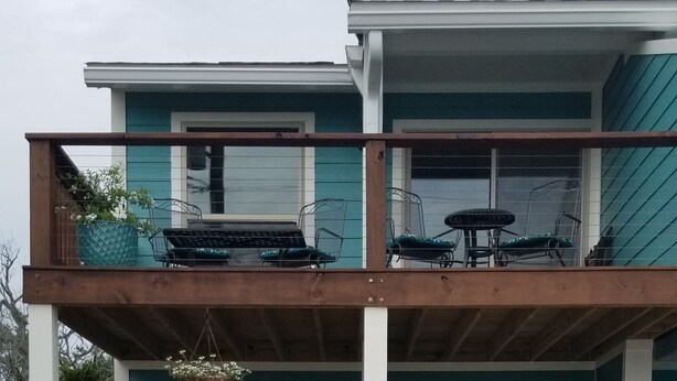Ein zweistöckiges Haus mit Balkon, Eingangstür und Briefkasten.