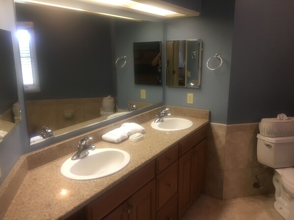A bathroom with two sinks, a large mirror, and a toilet. - Brigantine Quarters, Shipyard. Unit 292. 2BD/1.5Ba (Hilton Head Island)