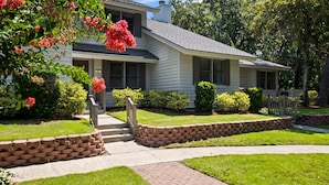 A single-story house with a front porch, a brick pathway, and a well-maintained lawn. - Brigantine Quarters, Shipyard. Unit 292. 2BD/1.5Ba (Hilton Head Island)