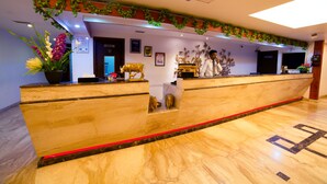 A reception desk with a marble counter, framed certificates, and a bull statue.