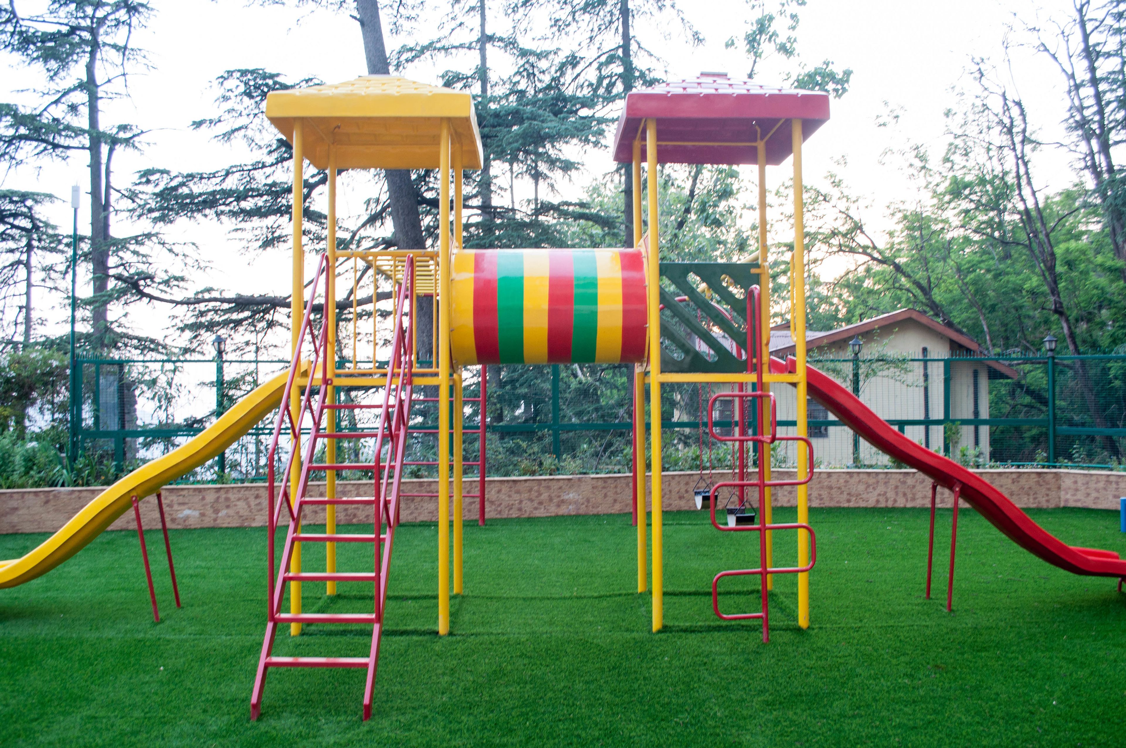 A playground with multiple slides and climbing structures.
