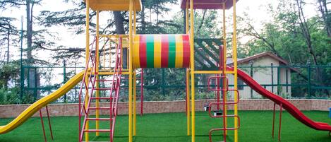 A playground with multiple slides and climbing structures.