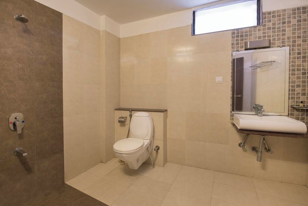 A bathroom with a shower, toilet, and sink.
