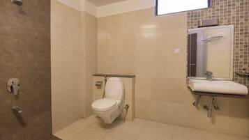A bathroom with a shower, toilet, and sink.