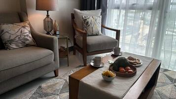 Deluxe Condo, Balcony, Mountain View | Living area | Flat-screen TV
