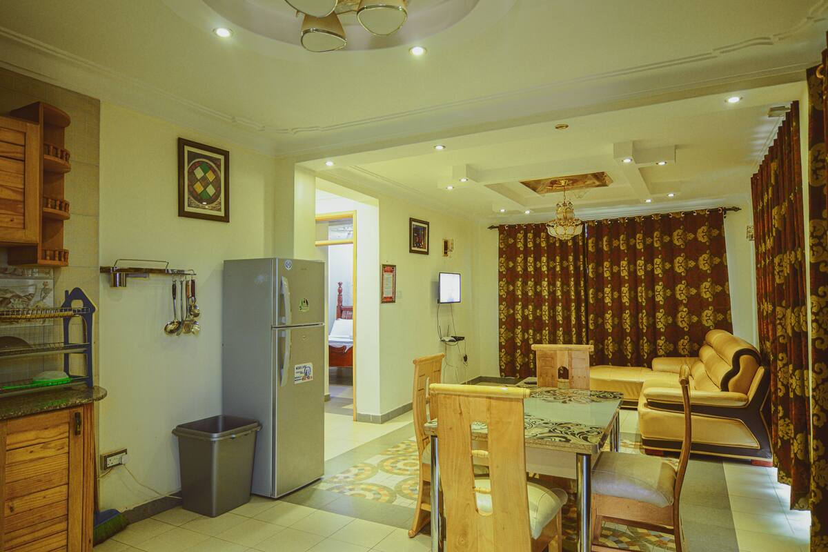 A compact living space with a kitchen, dining area, and a living room.