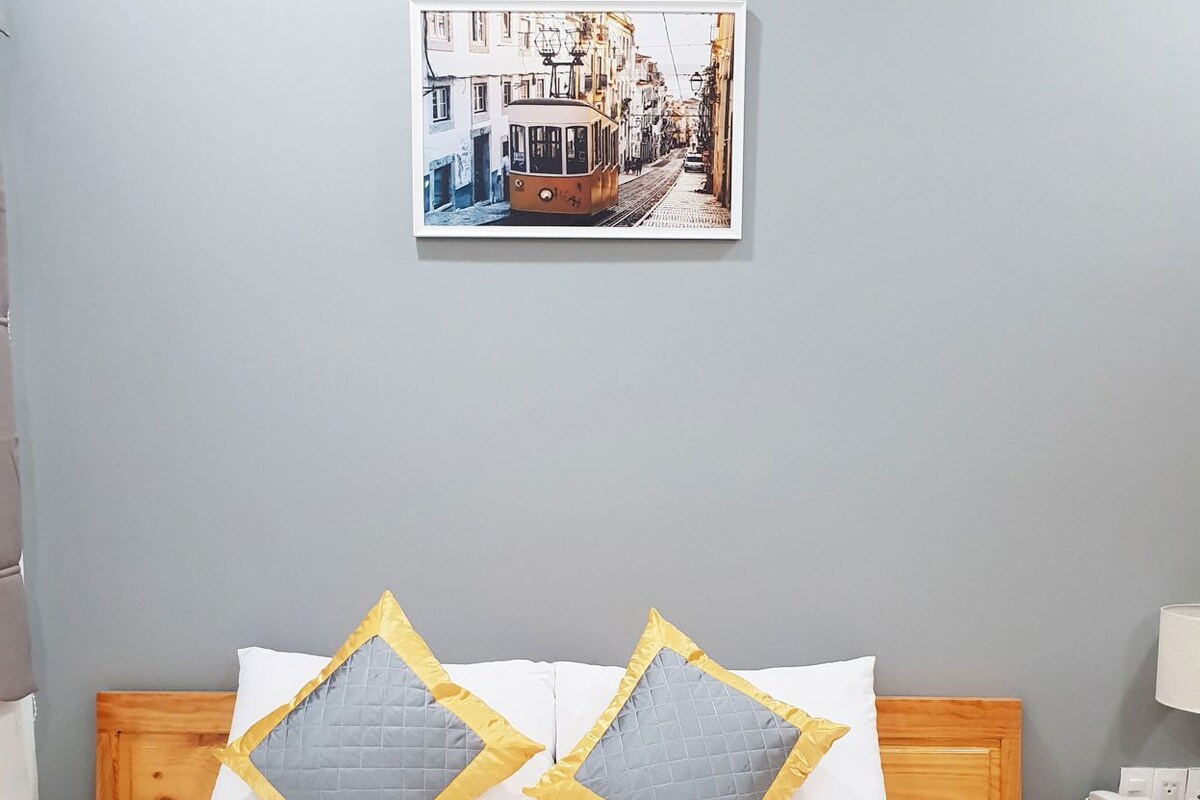 Premium bedding, desk, laptop workspace, blackout drapes