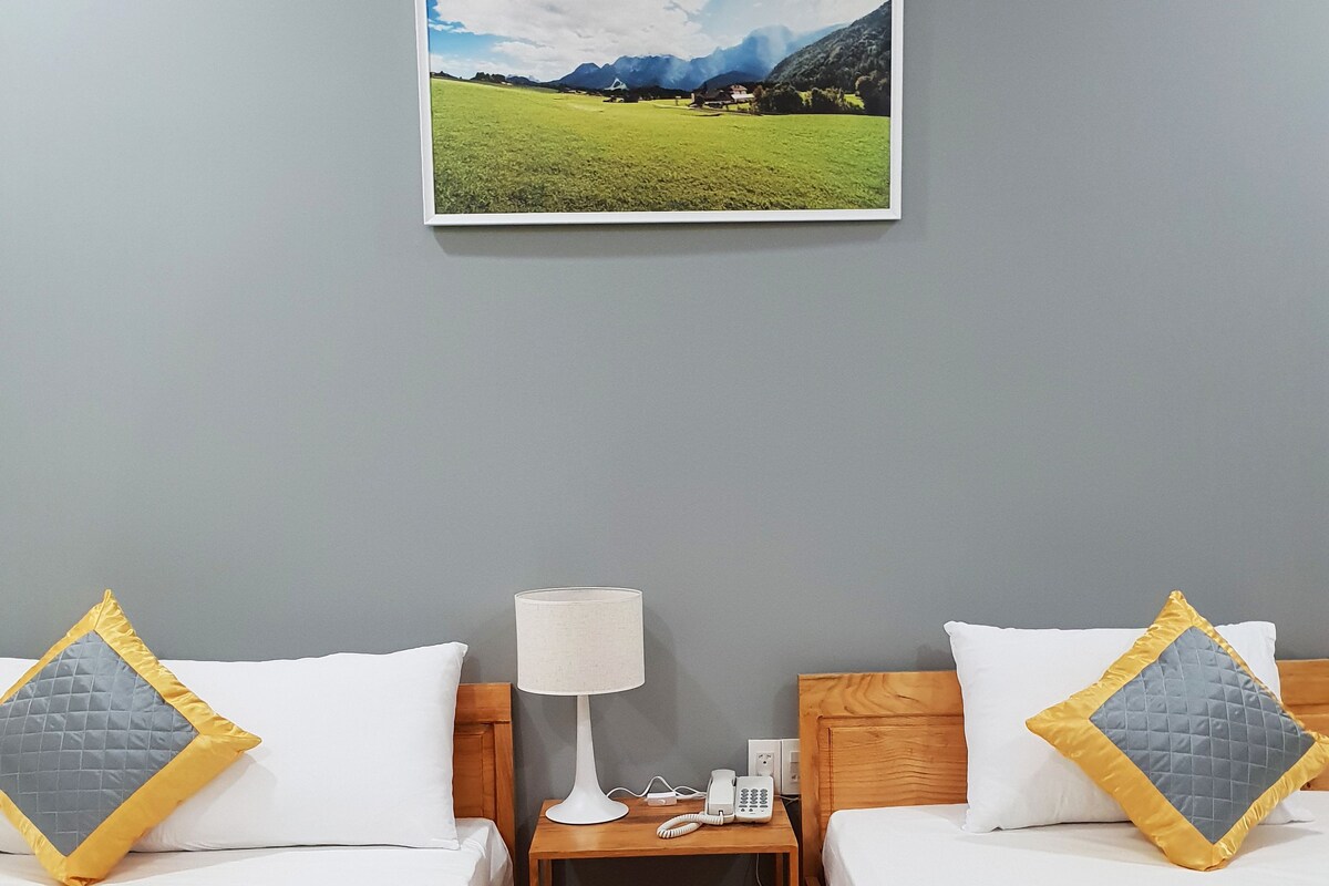 Premium bedding, desk, laptop workspace, blackout drapes