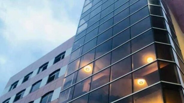 A modern building with a glass facade and multiple illuminated windows. - Bete Daniel Hotel (Bahir Dar)