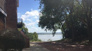 A pathway leading to a body of water, a brick building, and a fire hydrant. - Guest House 632 Summit Street (Alton)