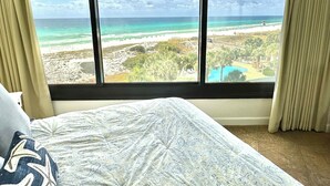 A bedroom with a large window offering a view of a beach and ocean. - Beautiful beachfront condo with Stunning Gulf Views!! 4061 BS1 (Miramar Beach)
