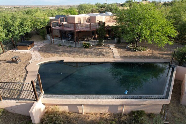 A swimming pool with a wooden deck and a covered patio area. - Mountain Getaway, Tranquility, Beauty, Ambience, Stunning View (Tucson)