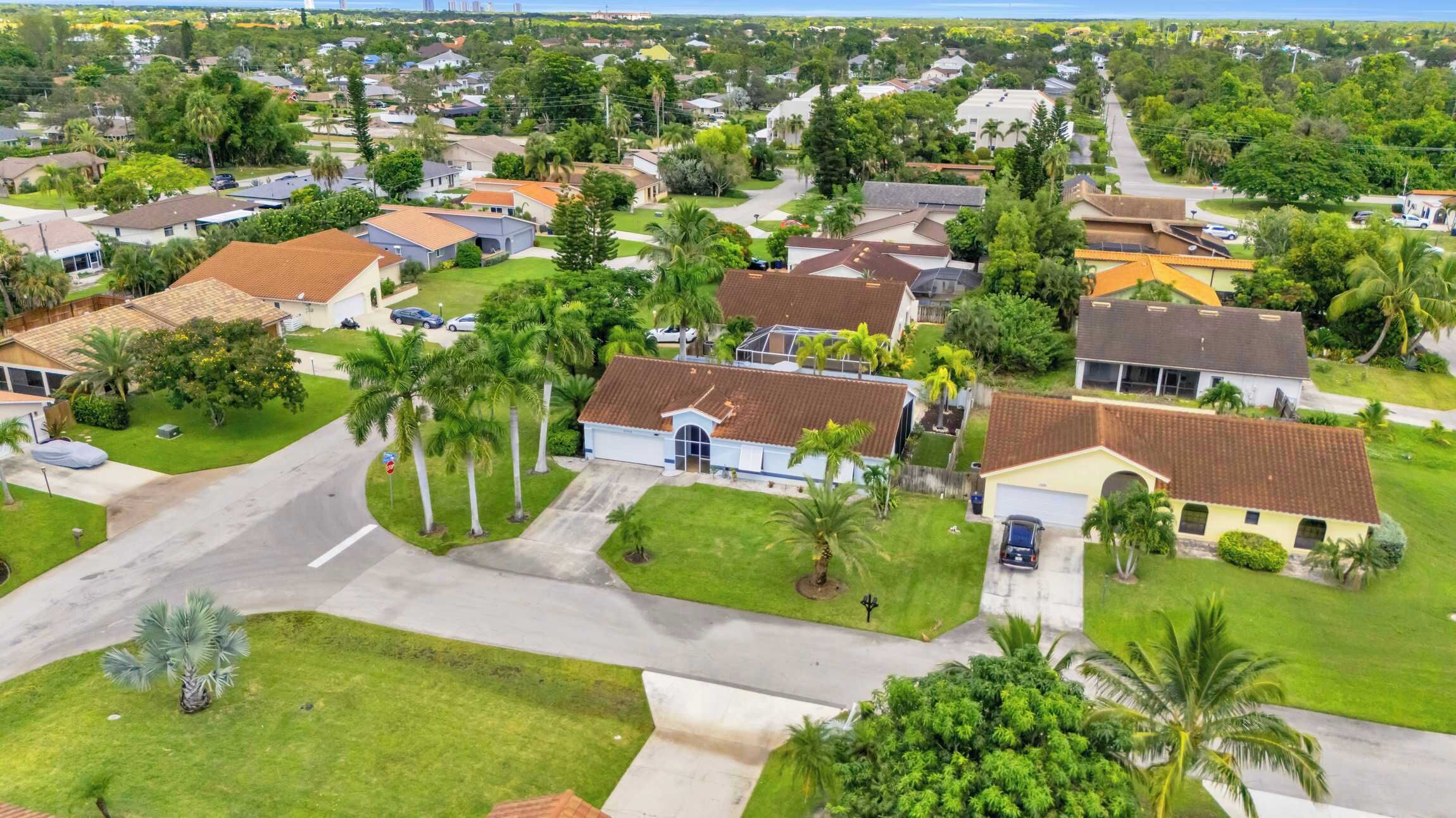 A residential area with houses, roads, and greenery.