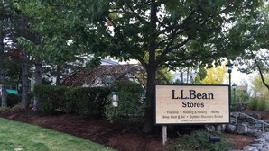 A sign for L.L.Bean Stores with a list of services including Flagship, Hunting & Fishing, Home, Bike, Boat & Ski, and Outdoor Discovery School. - The Nest ~ Quiet location close to shops, dining and Downtown Freeport. (Freeport)