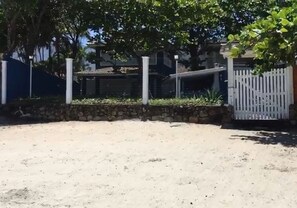 Stroll through a serene outdoor space surrounded by a low stone wall and white picket fence.