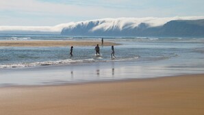 A beach with a sandy shore and waves.