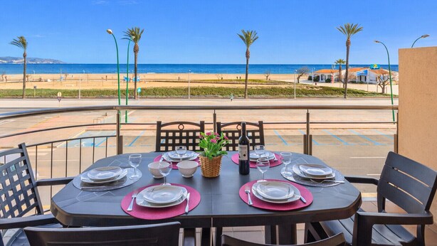 A table set for dining with a view of the beach and ocean. - 0086-BLAUCEL Apartment with seaview (Empuriabrava)