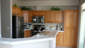 A modern kitchen with wooden cabinets, stainless steel appliances, and a white countertop. - Florence old town (Florence)