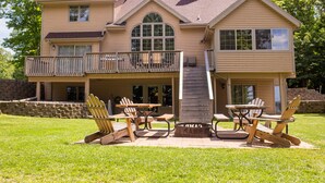 A two-story house with a balcony, outdoor seating, and a fire pit. - Private - Secluded Lake Home/Sleeps up to 20 people (Deerwood)