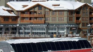 A multi-story lodge with wooden balconies and a snow-covered roof. - Best Location in The Center Village at Copper Mountain! (Copper Mountain)