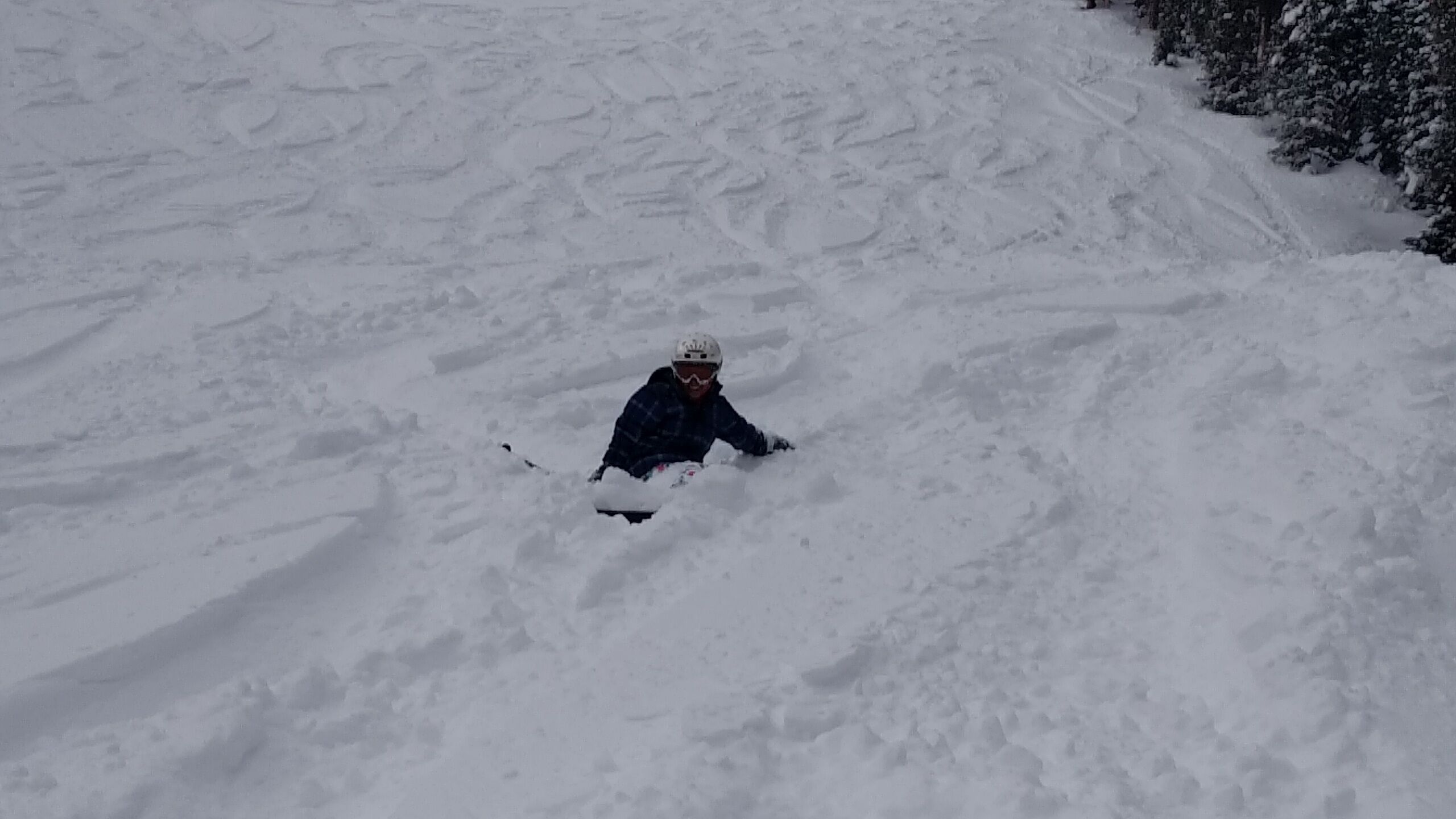A person snowboarding down a snowy slope.
