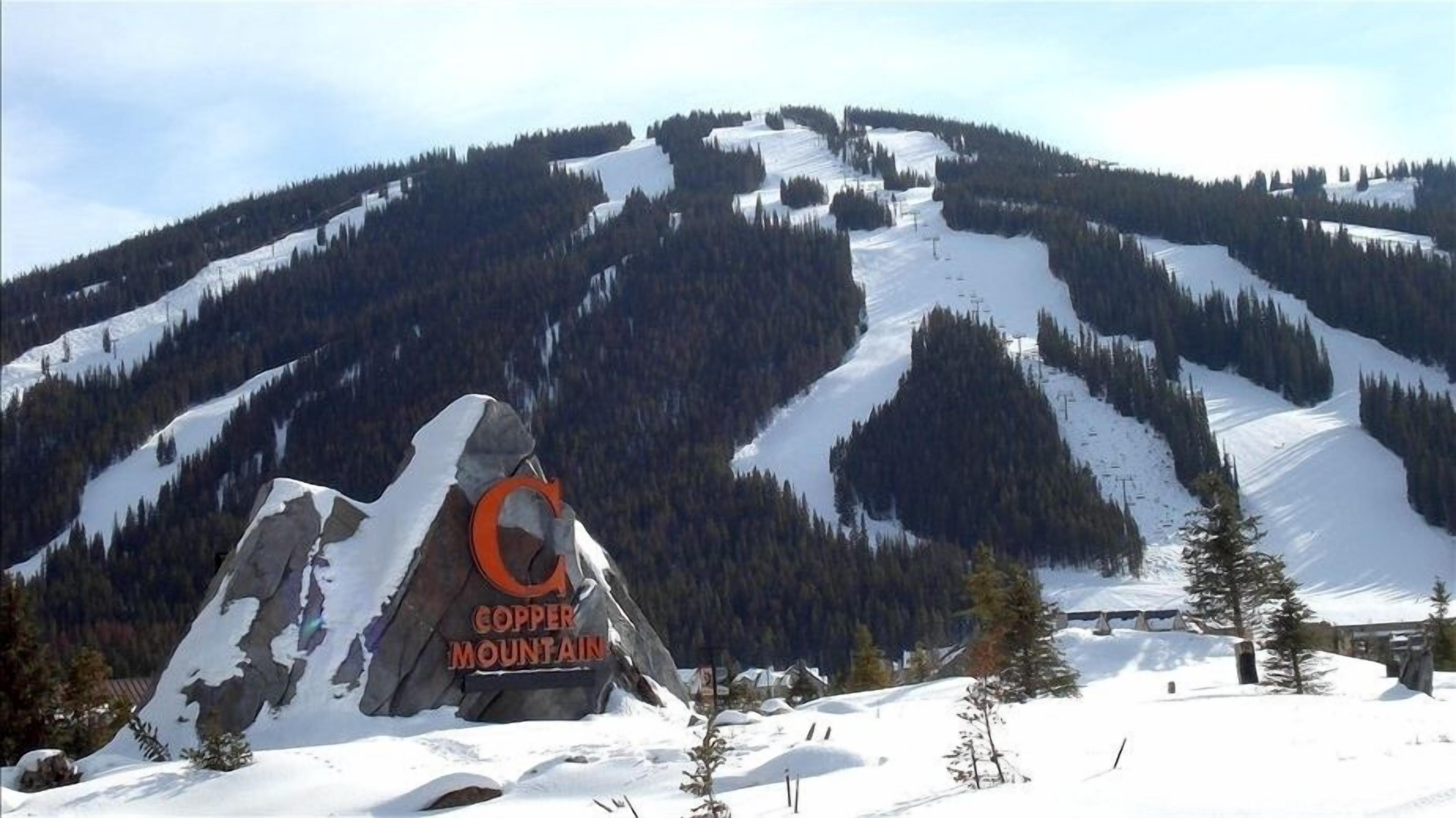 A snow-covered mountain with a sign reading "Copper Mountain."