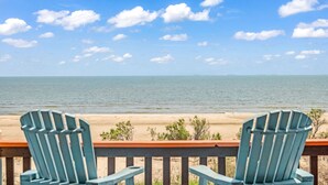Two Adirondack chairs facing a beach with a clear sky. - Amazing View, Gorgeous Beachfront, Huge Deck, Luxury Retreat-Sleeps 14, Starlink (Crystal Beach)
