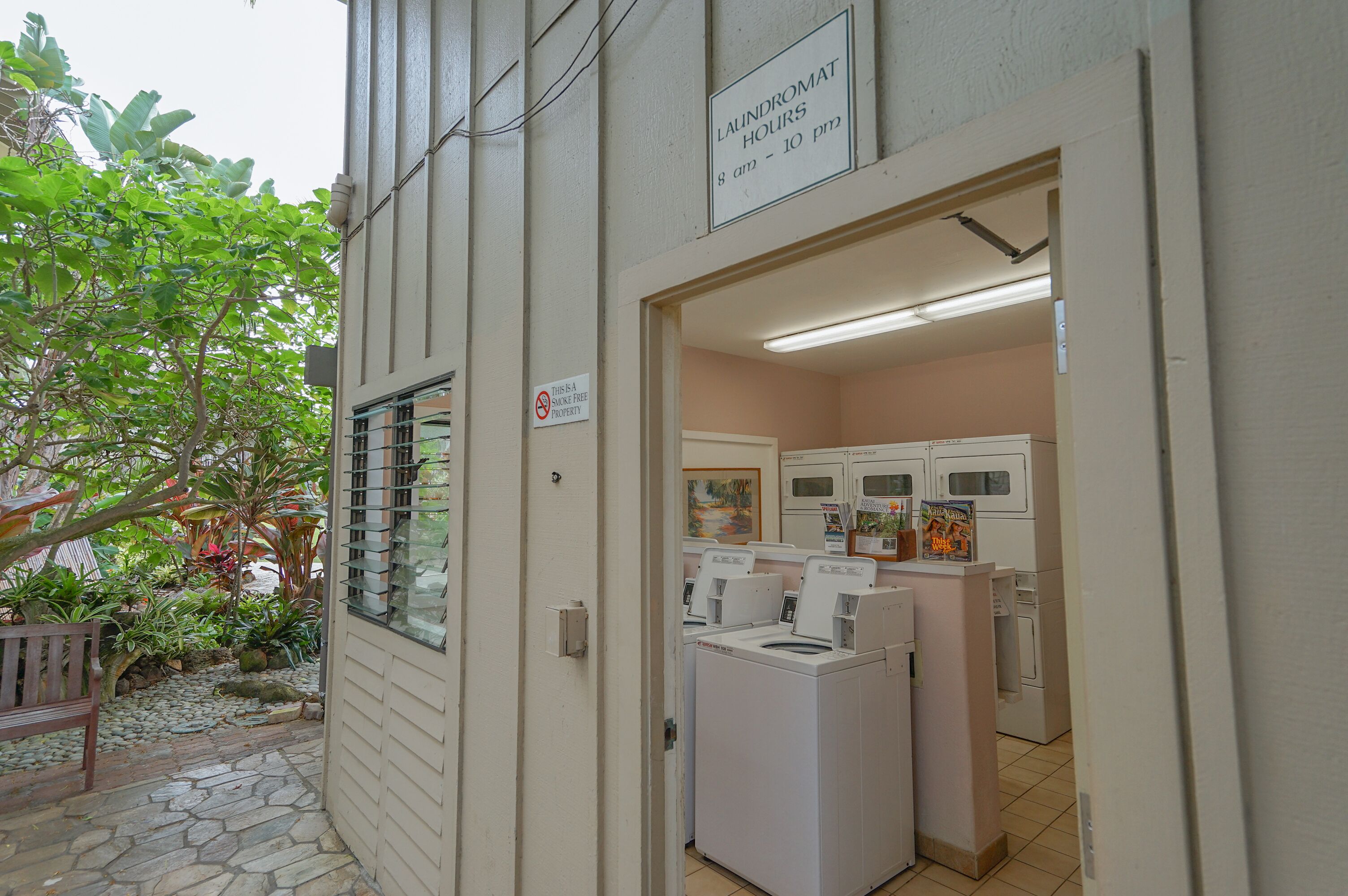 A laundry facility with a sign indicating hours of operation.