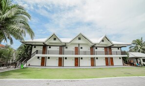Ein mehrstöckiges Hotel mit symmetrischer Fassade, mehreren Balkonen und einem Flachdach.