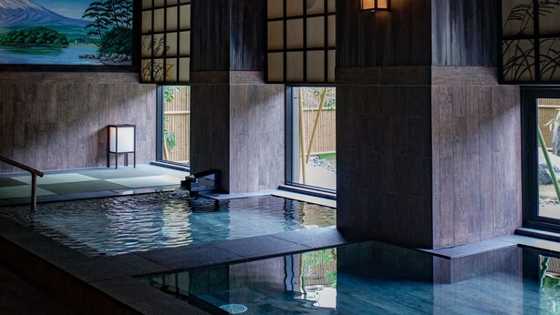A traditional Japanese-style interior with a wooden ceiling, tatami flooring, a koi pond, and a large painting of Mount Fuji. - Roygent Parks Hanoi (Hanoi)