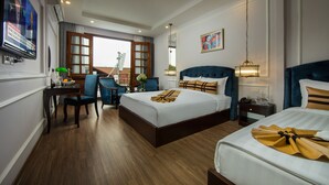A hotel room with two beds, a desk with a chair, a TV, and a large window. - S Central Hotel & Spa (Hanoi)