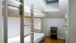 Ein Mehrbettzimmer mit Fernseher an der Wand.