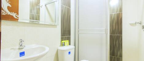 A bathroom with a sink, toilet, and shower.