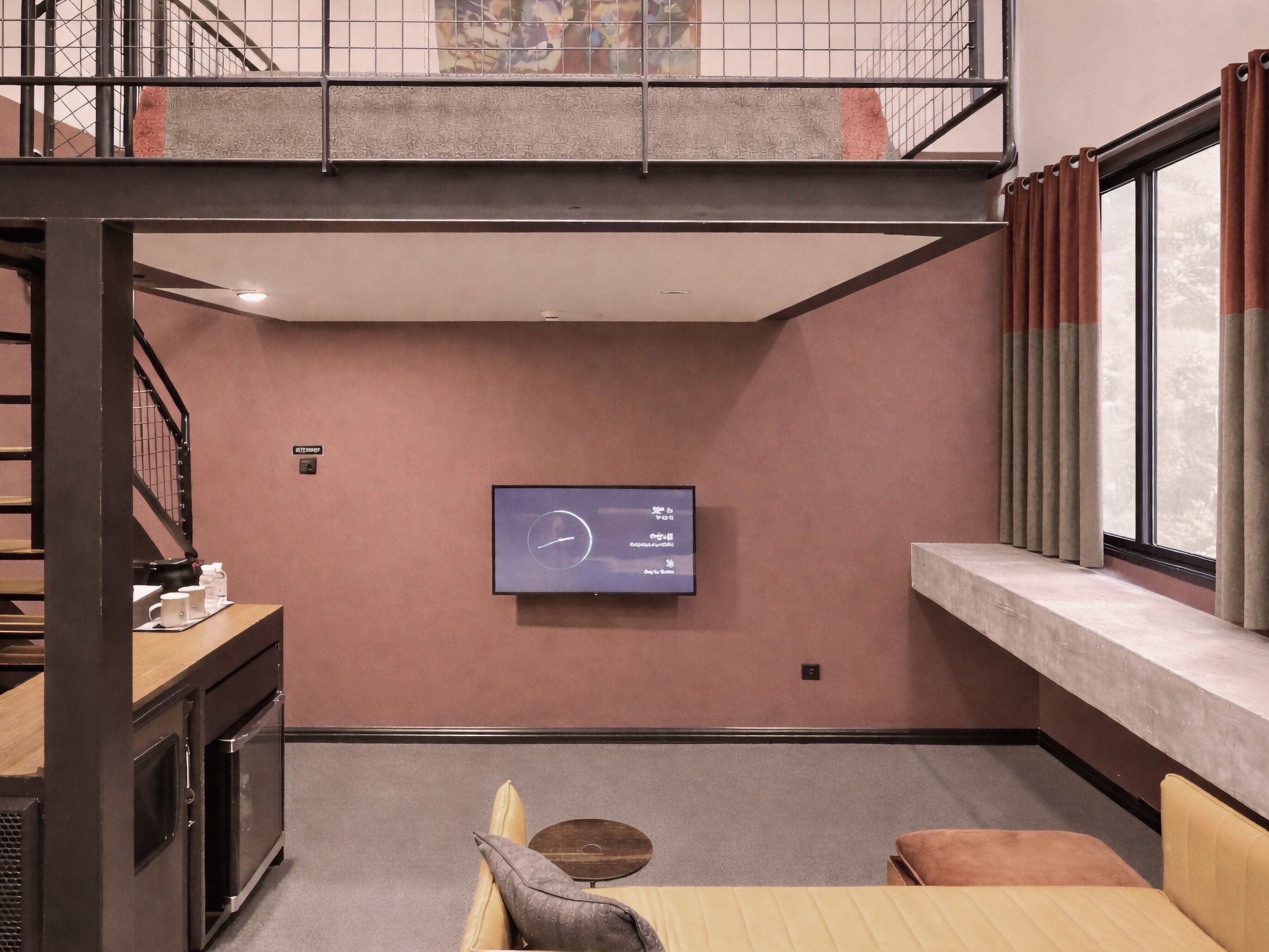 A modern interior with a flat-screen TV mounted on the wall, a wooden bench, and a sofa.