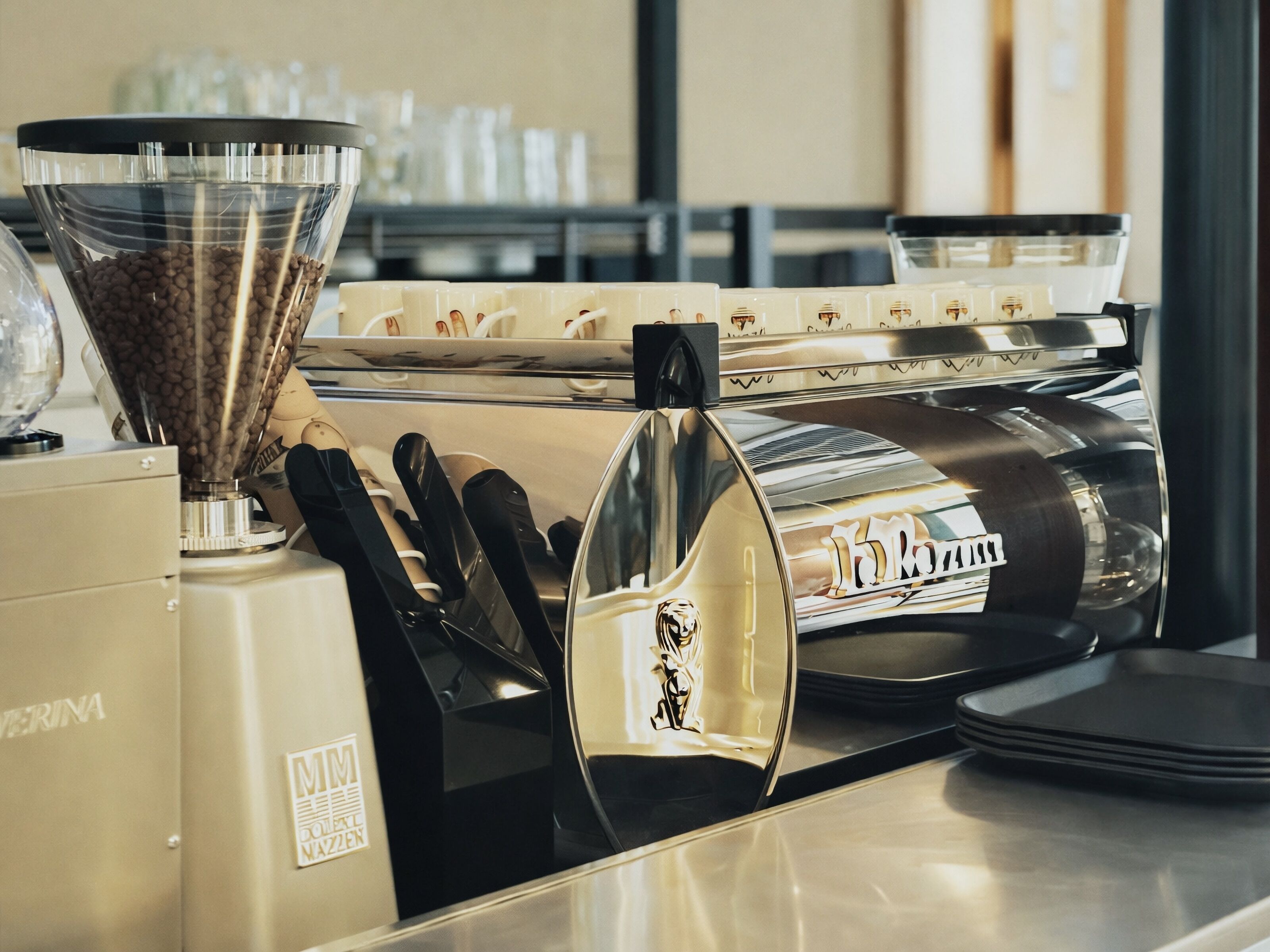 A coffee machine with a milk frother and a coffee grinder.