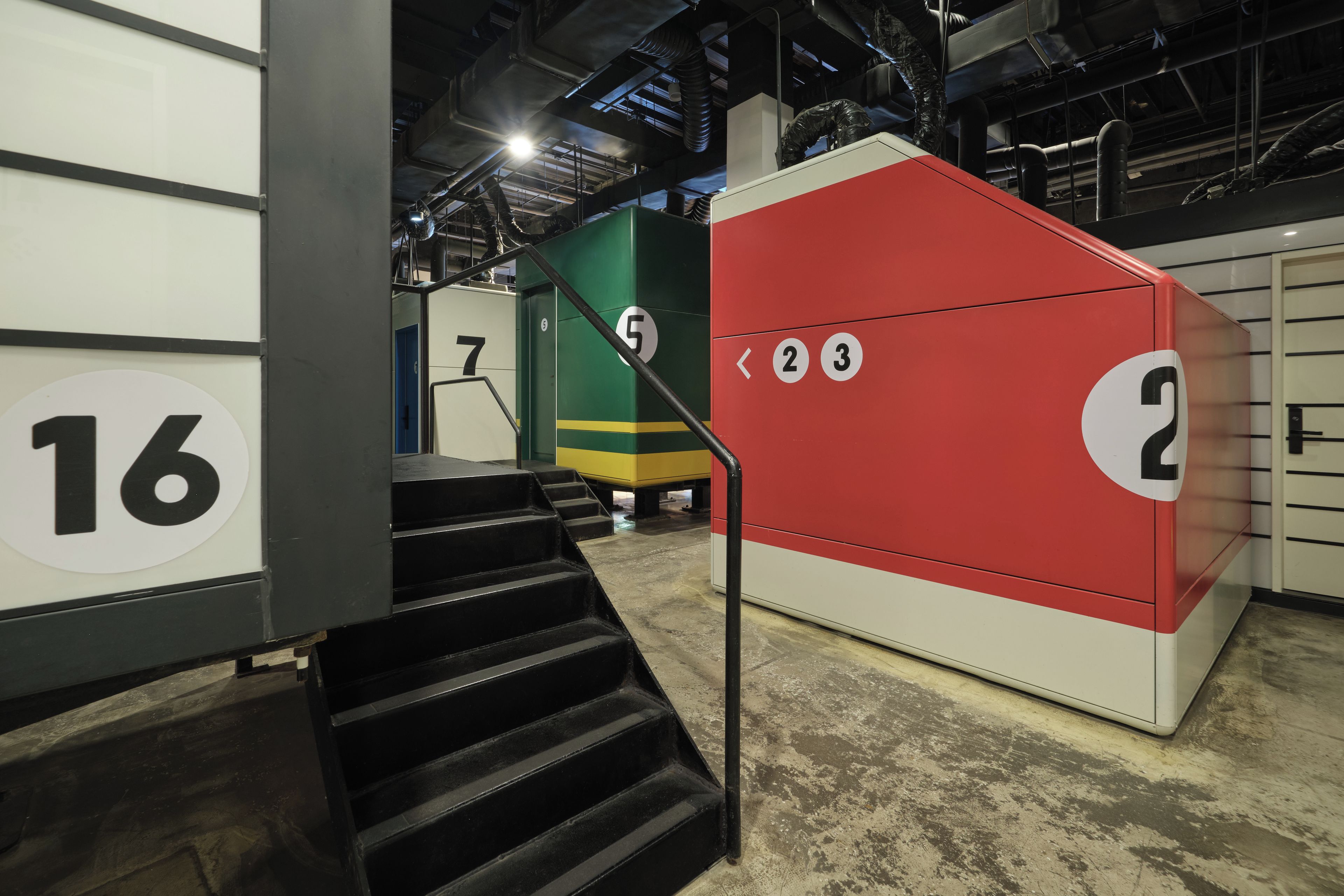A staircase leading to a set of numbered rooms, with a visible room number 16 and a red room with numbers 2 and 3.