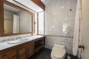 A bathroom with a wooden vanity, a sink, a toilet, and a shower area. - Lima Fabulous  House 5br sleep8 Next Mall (Lima)