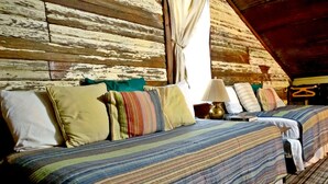 A cozy room with two beds, a lamp, and a window with curtains. - The Baines House Inn (Salado)