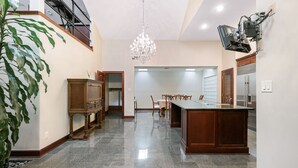 A spacious kitchen with granite countertops, a wooden island, and a chandelier. - Exquisite house with loft . Great deals for longer stays (Houston)