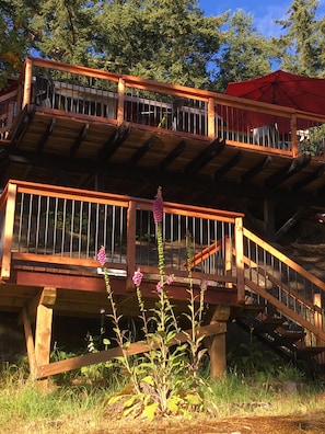 Stunning multi-level structure with balconies and staircases, offering panoramic views of the surrounding trees and foliage.