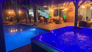 A pool area with a hot tub, lounge chairs, and a covered seating area with ambient lighting. - Detached Villa with Private Pool, close to all amenities and a blue flag beach (Santiago del Teide)