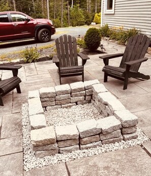 A fire pit surrounded by wooden chairs and benches on a stone patio. - secluded beauty! Just minutes from Phoenicia, Hunter, skiing & hiking (Chichester)