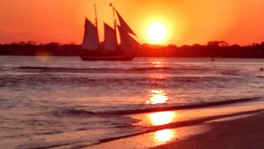 A sunset over a calm body of water with a sailboat. - Comfy Safe Quiet Haven, Dog Friendly!  2 Miles to Downtown or to Vilano Beach (St. Augustine)