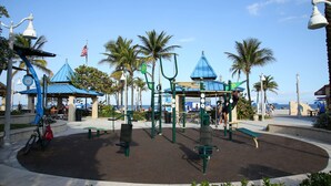 A park with exercise equipment, benches, and a gazebo.