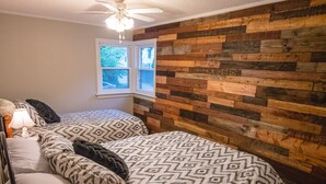 A bedroom with a bed, pillows, a nightstand, a lamp, a window, and a ceiling fan. - The Lily Pad - quaint home in Old Town NOTL, steps from the lake! (Niagara-on-the-Lake)
