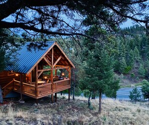 A wooden cabin with a balcony, surrounded by trees and a view of a lake. - Privacy & Location! One acre & 2min from town. Central AC. Covered patio. (Ruidoso)