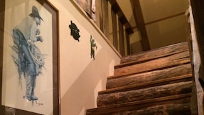 A wooden staircase with a framed artwork on the wall. - Privacy & Location! One acre & 2min from town. Central AC. Covered patio. (Ruidoso)